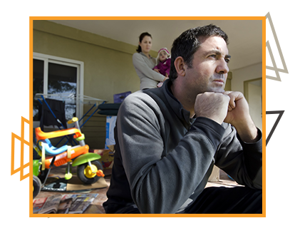 sad man sitting on porch in front of wife and child