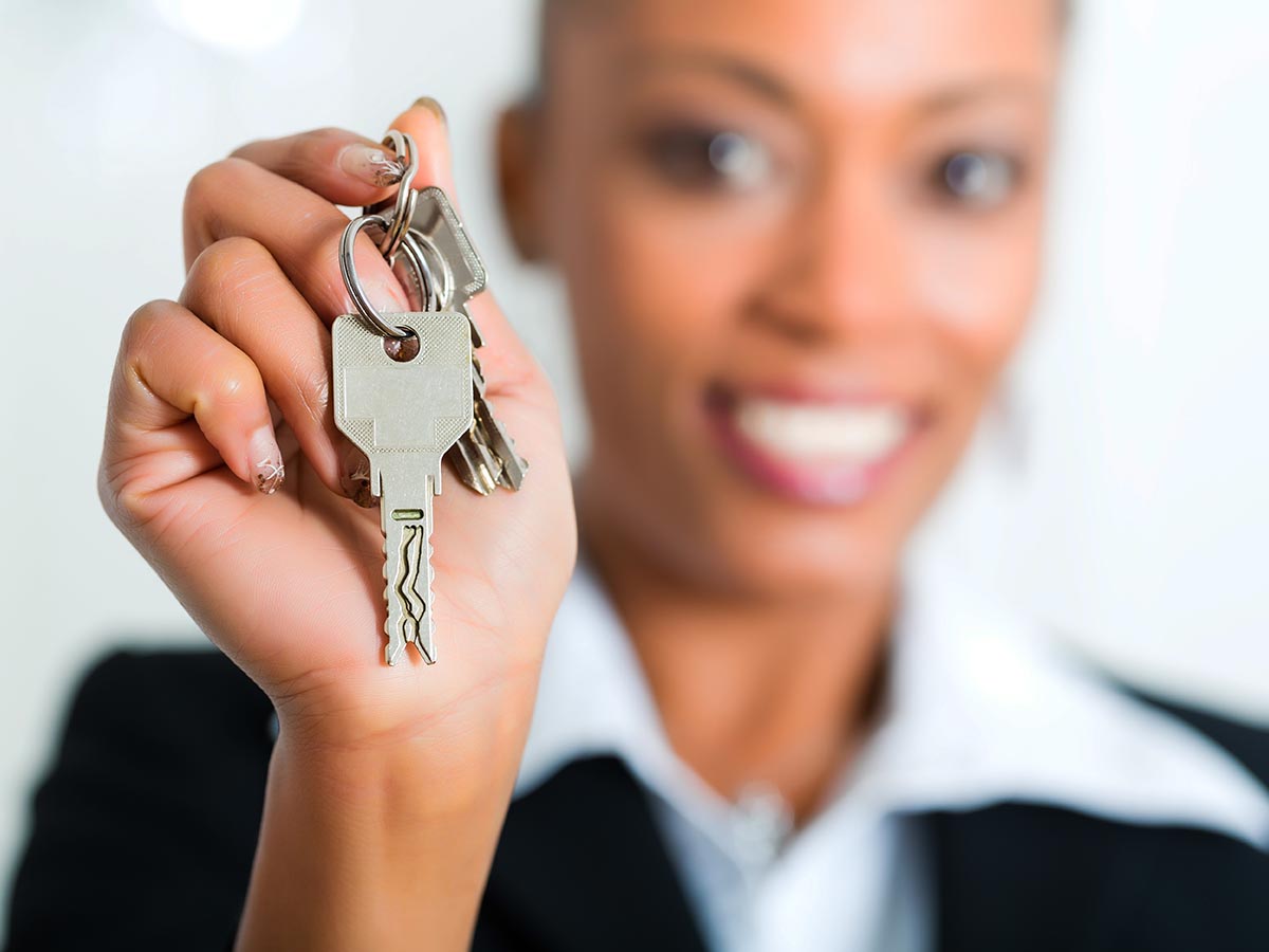 Landlord handing over keys to a house. 