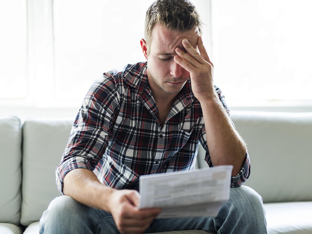 A landlord handing over keys to two tenants.