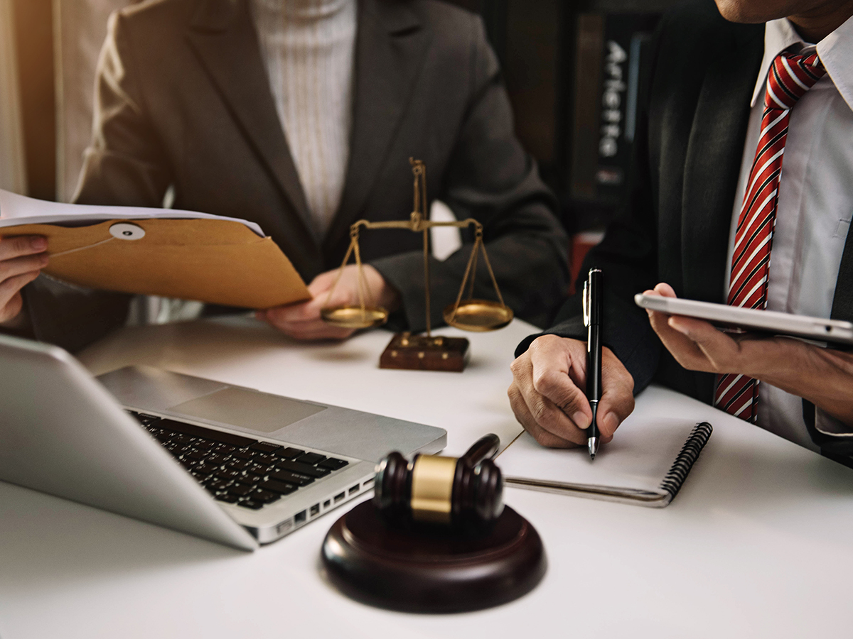  Lawyer businessman and two business partners working together in a law office.