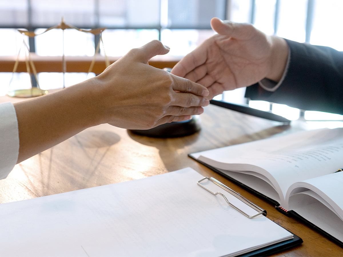Lawyer shaking hands with client