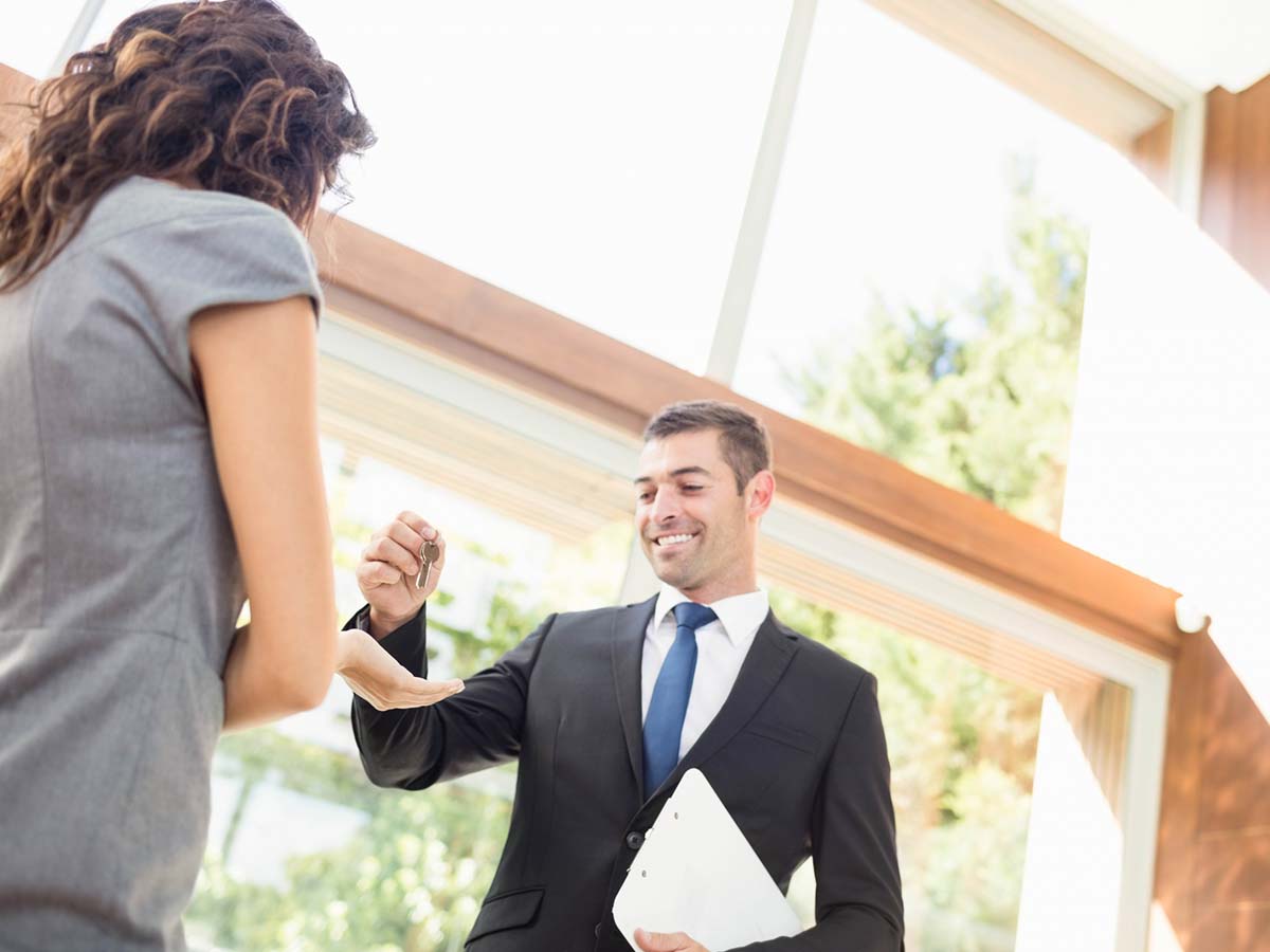 A man handing over the keys to a property