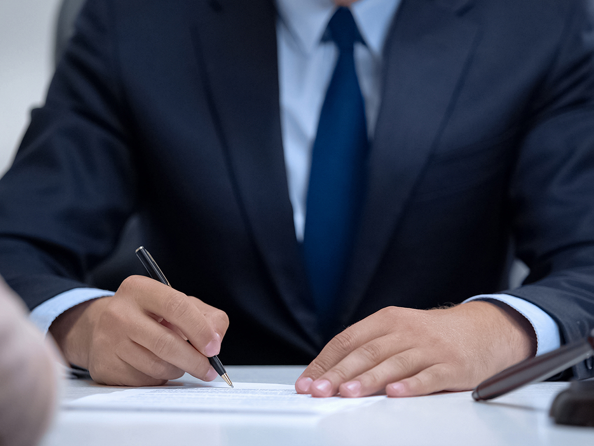 Lawyer taking notes during meeting