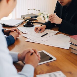 an attorney going over paperwork with a client
