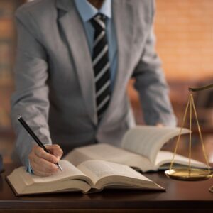 a lawyer looking at many books and taking notes