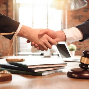 an attorney and client shaking hands