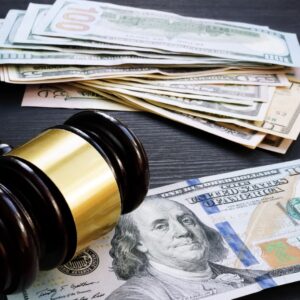 a stack of money and a gavel