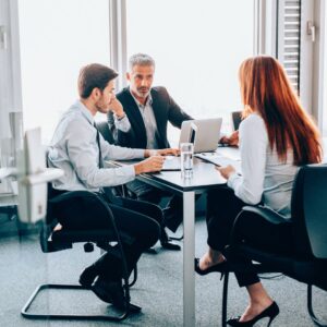 Three people in a business meetig