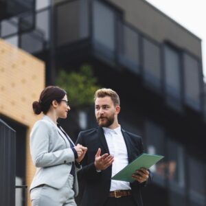 Real estate agents talking outside of a property