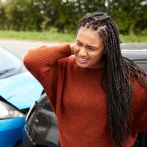 person touching neck after car accident