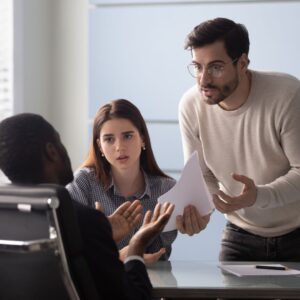 two people arguing over a contract with a lawyer