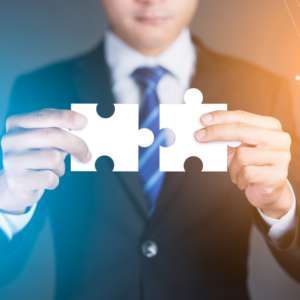 a man putting two puzzle pieces together