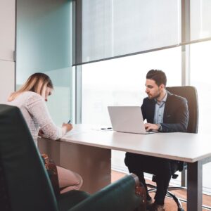 Woman filling out form at lawyers desk