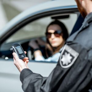 Cop looking at breathalyzer