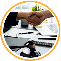 two people shaking hands over a gavel hamer