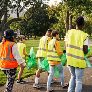 people in high visibility gear  picking up trash