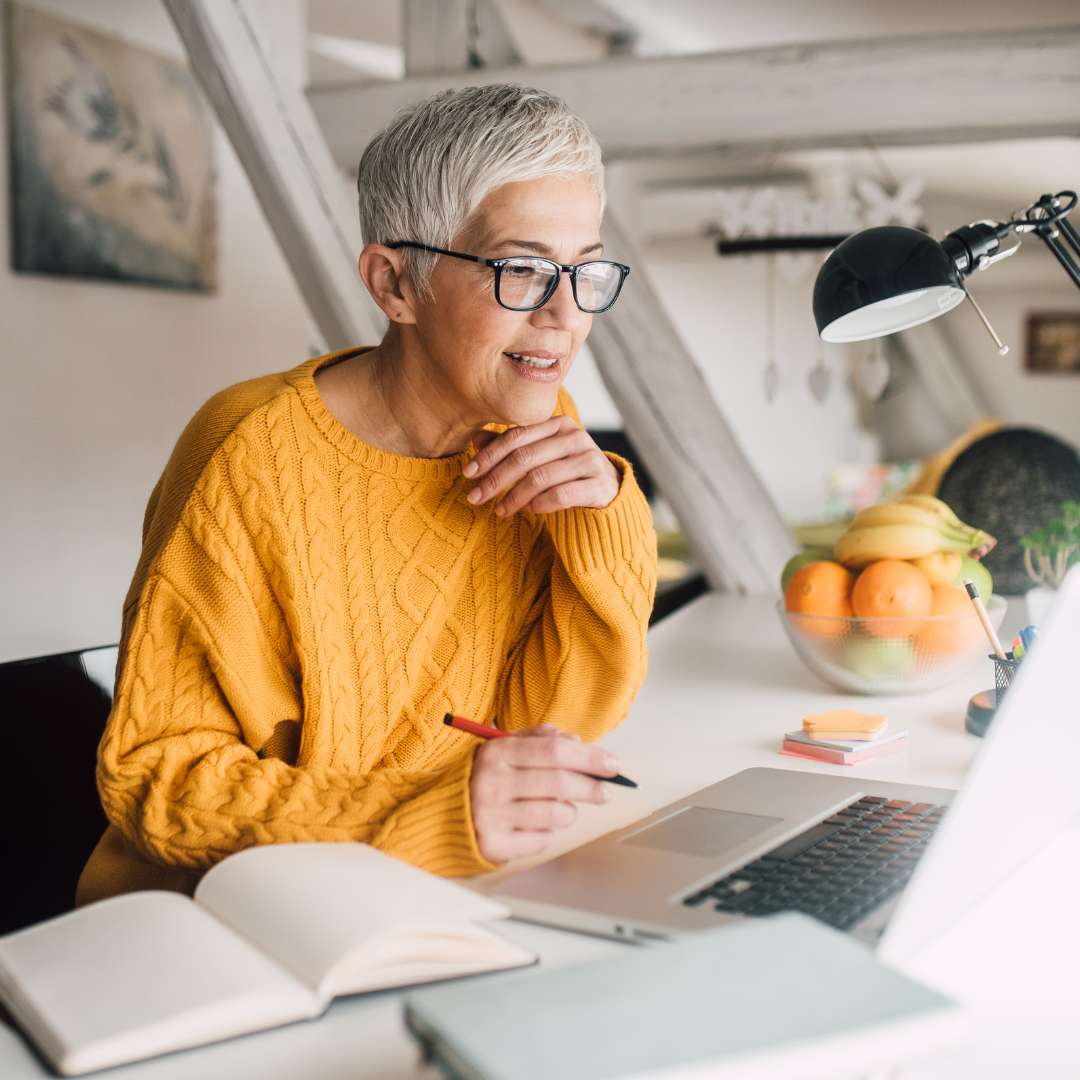 older woman researching on computer