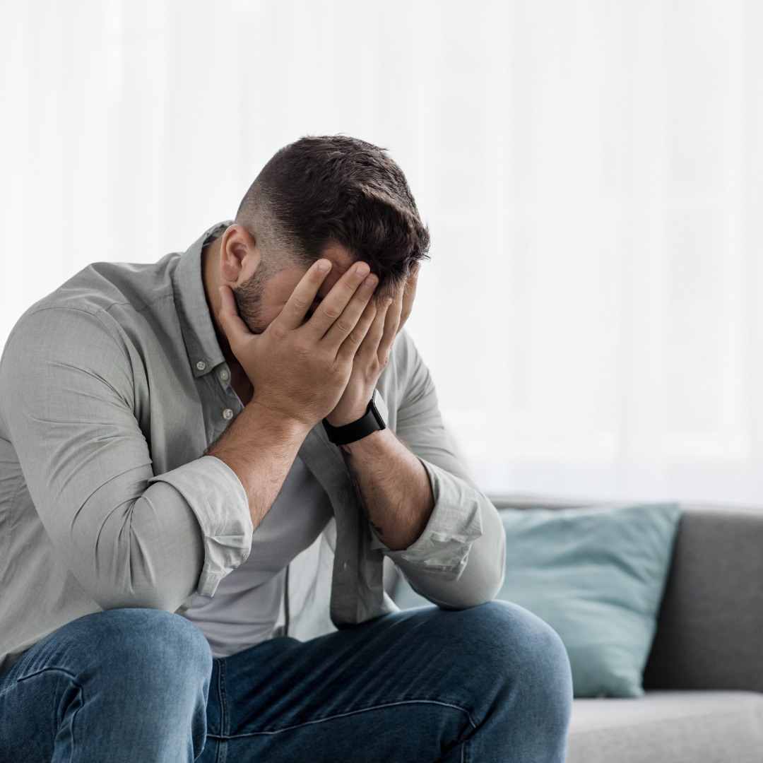 man with face in hands