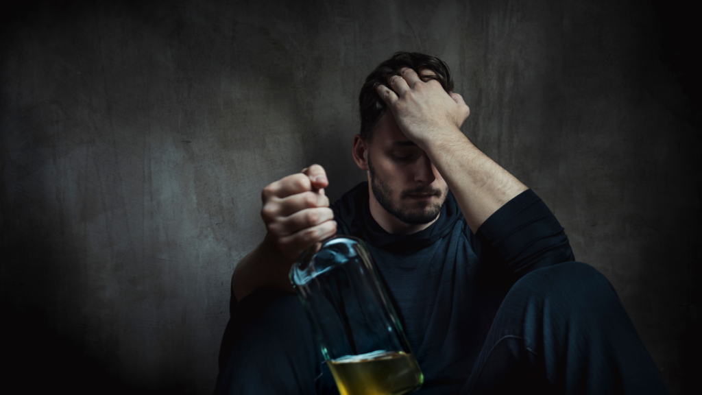man holding a bottle of liquor