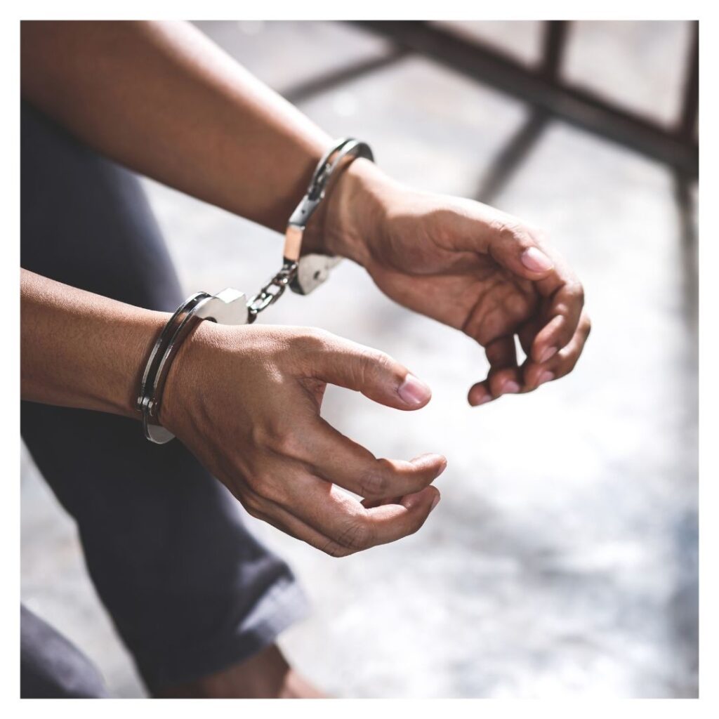 person in handcuffs