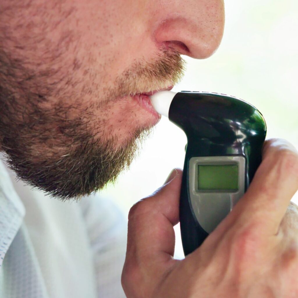 A man using breathalyzer 