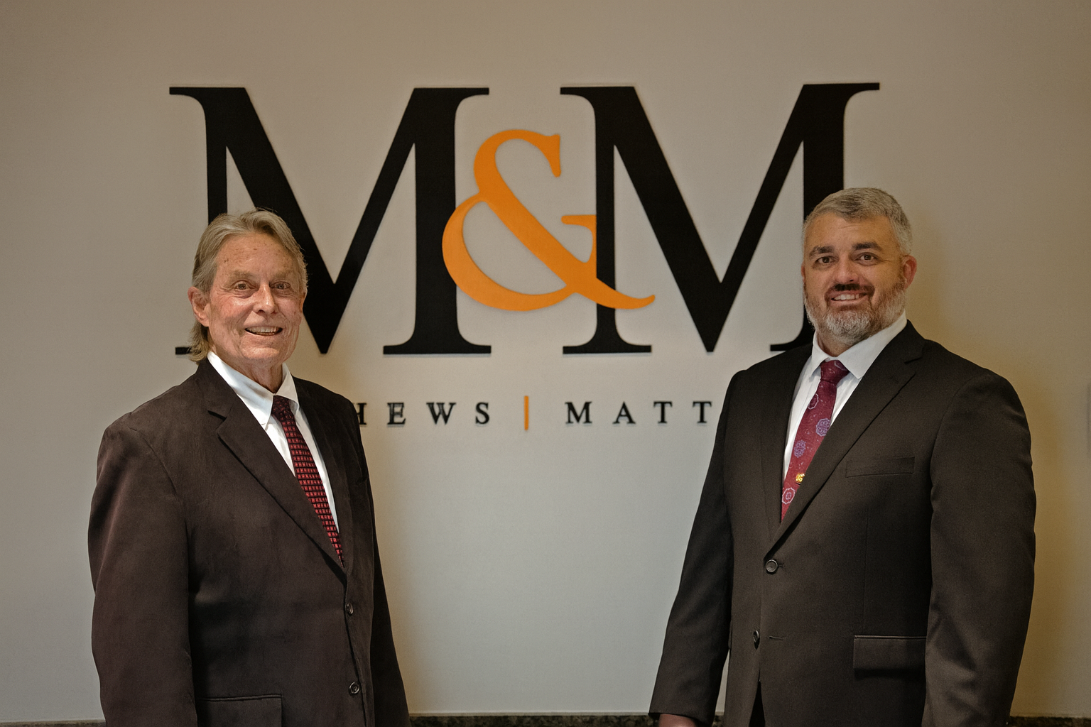 Professional Duo in front of M&M Logo