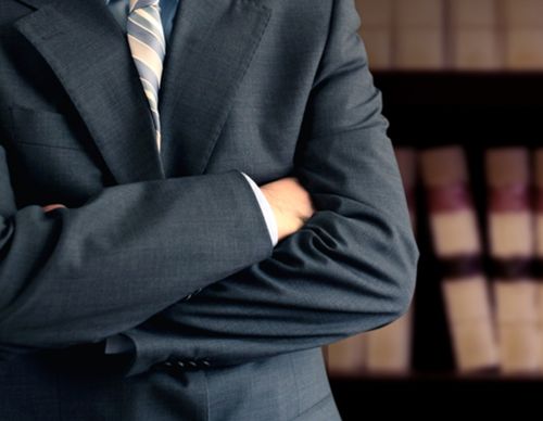 man in suit with arms crossed
