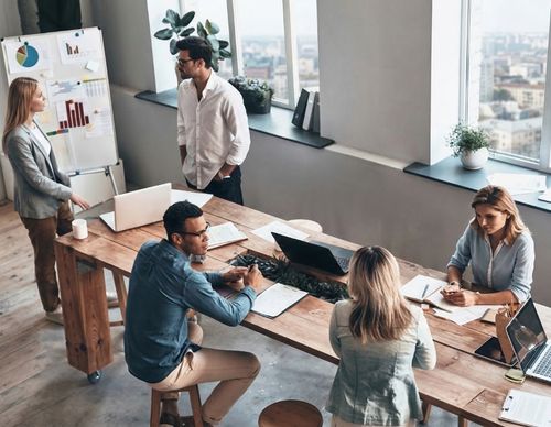 Diverse professional team collaborating at a long wooden table
