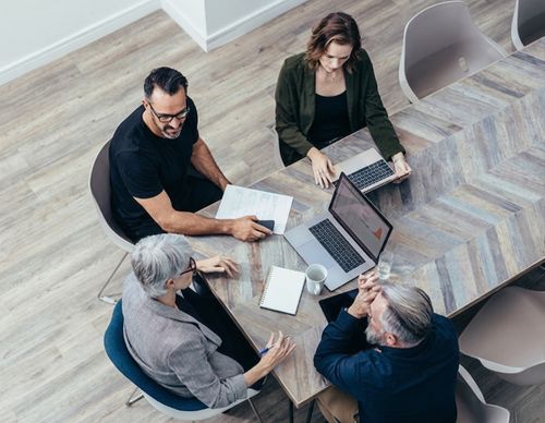 Overhead view of a diverse team in a meeting.