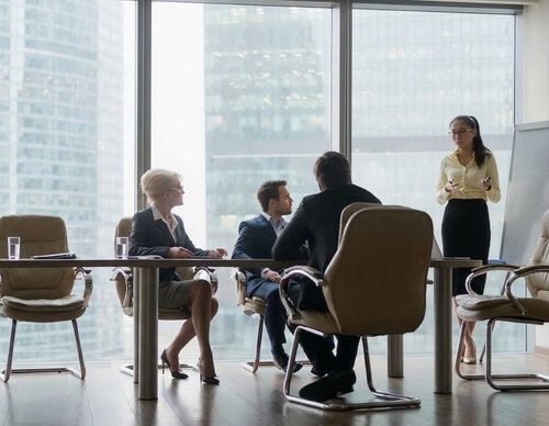 Woman giving a presentation in a modern boardroom.