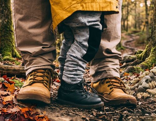 adult and child boots in forest