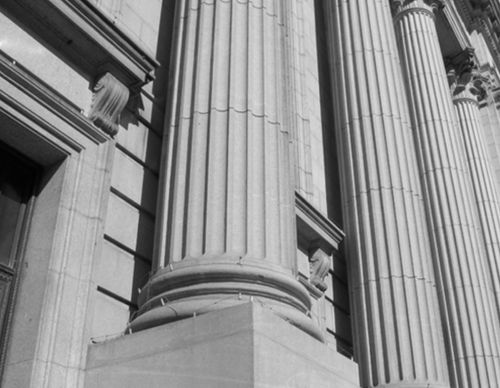 Close-up of large stone columns on a government building