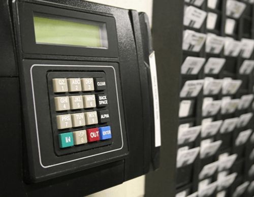 Employee time clock and punch card rack.
