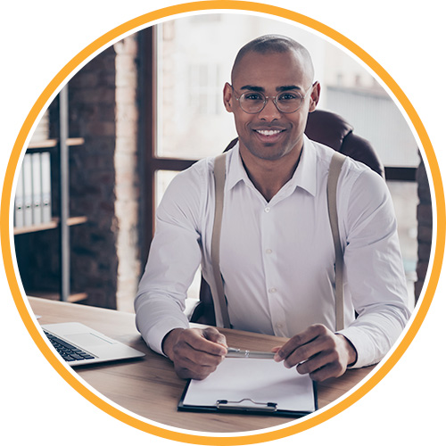 man smiling at a desk