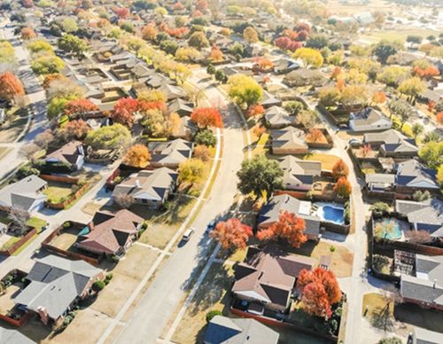 High-angle view of a suburban neighborhood with autumn trees