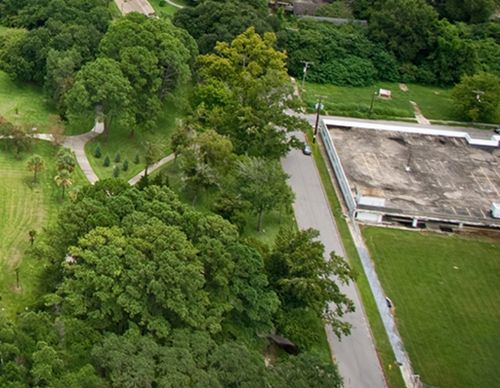 Aerial view of a commercial building next to woods.