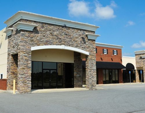 Exterior of a modern stone and brick retail storefront.