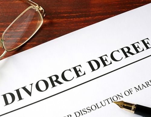 Close-up of a Divorce Decree document and glasses.