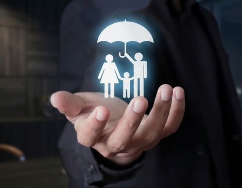 Glowing family icon under an umbrella in a hand.