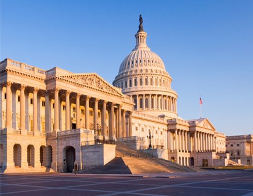 The United States Capitol building under a clear sky.