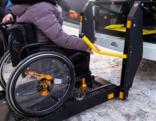 A person in a wheelchair using a vehicle lift.