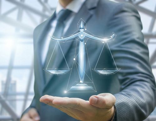 Digital glowing scales of justice hovering over a hand.