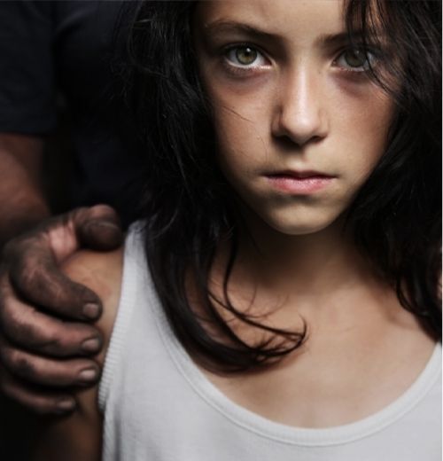 Close-up of a young girl with a serious expression.