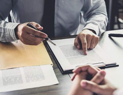 Businessman pointing to specific text on a legal contract