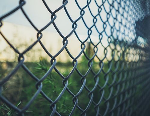 Close-up of a gray metal chain-link fence