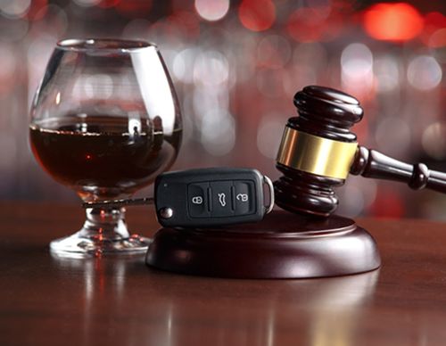 Gavel, car keys, and a glass of liquor