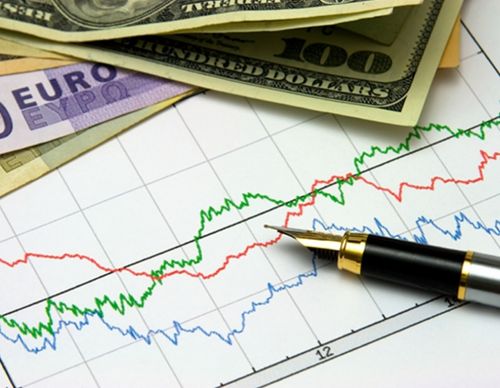 Fountain pen on stock market charts with banknotes