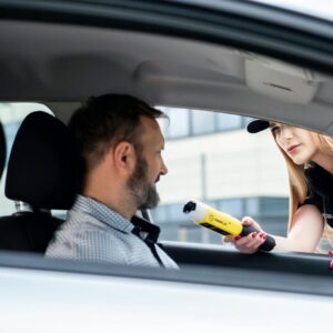 a man stopped to take a breathalyzer while sitting in the driver's seat