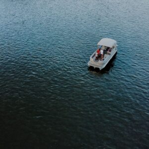 Aerial view of a pontoon boat with passengers on the water, representing maritime law and boating safety cases in Destin.